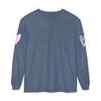 A slate blue long-sleeve t-shirt with a light pink heart graphic on each sleeve, displayed flat against a solid white background.