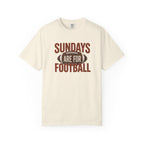 An off-white short-sleeve crewneck t-shirt with a graphic on the front that reads 'SUNDAYS ARE FOR FOOTBALL' in brown, featuring a football illustration in the center.