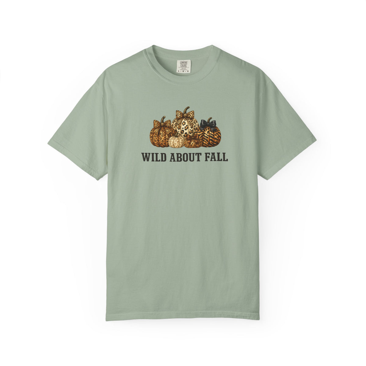 A sage green short-sleeve t-shirt with a graphic of pumpkins and the text 'WILD ABOUT FALL' printed on the chest, displayed against a plain white background.