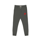 Dark gray jogger pants with a small red star logo on the left thigh and a white drawstring at the elastic waistband, shown against a plain white background.