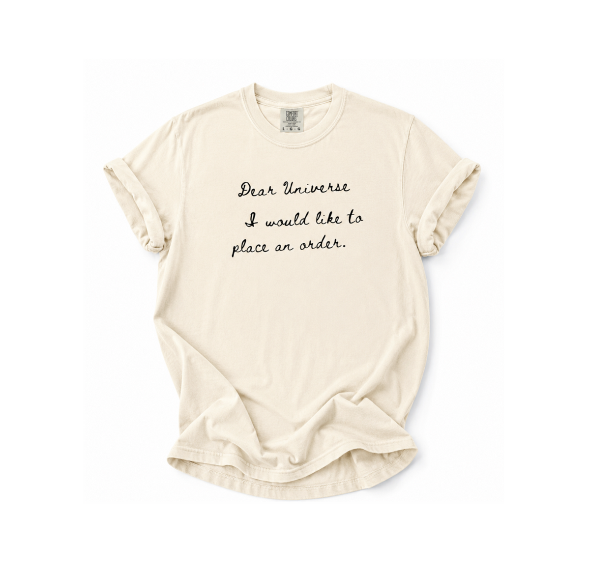Beige t-shirt with text 'Dear Universe I would like to place an order' on a white background