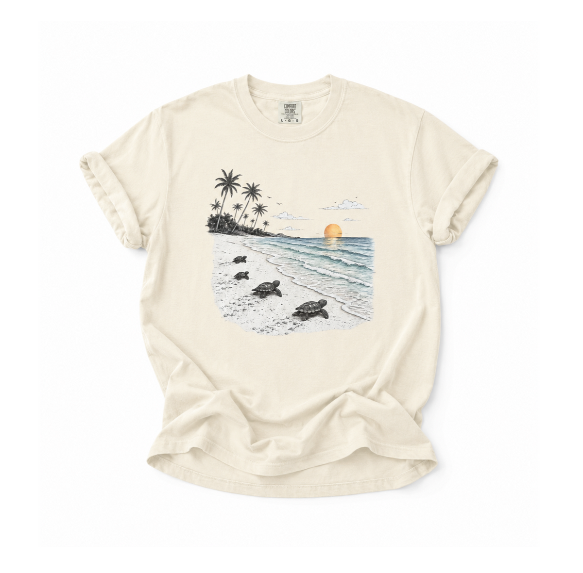 An off-white short-sleeve t-shirt with a graphic print of a tropical beach scene featuring sea turtles, palm trees, and a sunset, laid flat on a white background.